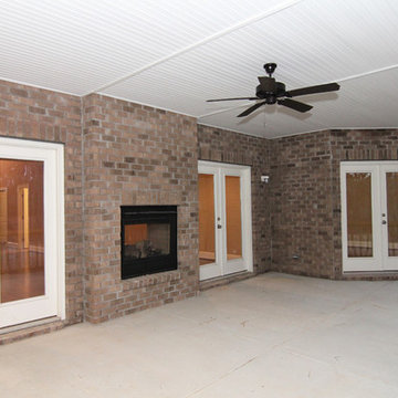 Two Sided Fireplace in Backyard Screen Porch