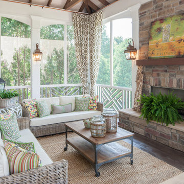 Two story double porch with outdoor fireplace, travertine patio, and AZEK deck