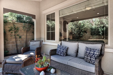 Inspiration for a mid-sized eclectic stone back porch remodel in Orange County with a fire pit and a roof extension