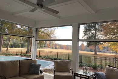 Mid-sized transitional stone back porch photo in Raleigh with a fire pit and a roof extension