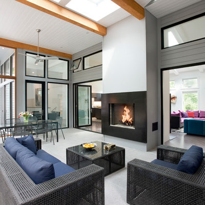 Inspiration for a large contemporary tile screened-in back porch remodel in Boston with a roof extension