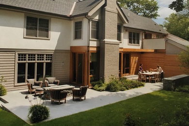 Imagen de terraza moderna grande en patio trasero con brasero, adoquines de piedra natural y pérgola