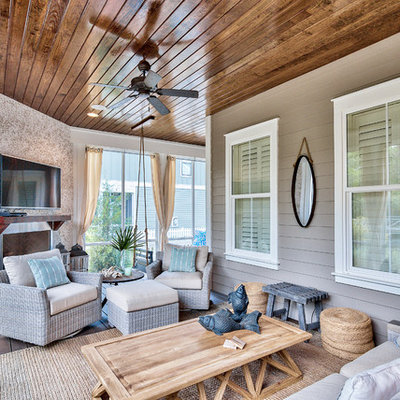 Beach style screened-in back porch photo in Miami with decking and a roof extension
