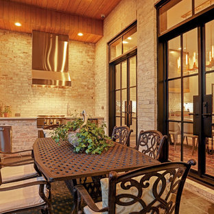 Immagine di un ampio portico chic dietro casa con piastrelle e un tetto a sbalzo