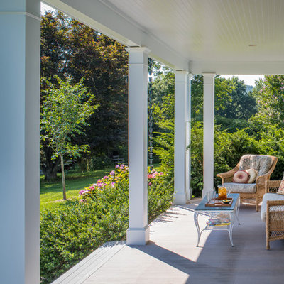 Inspiration for a farmhouse front porch remodel in DC Metro with decking and a roof extension