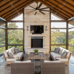 Design ideas for a transitional backyard screened-in verandah in Austin with a roof extension.
