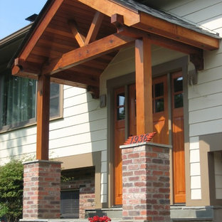 Esempio di un portico stile americano di medie dimensioni e davanti casa con piastrelle e una pergola