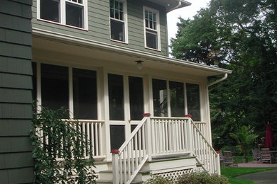 Mid-sized arts and crafts brick screened-in side porch photo in New York with a roof extension