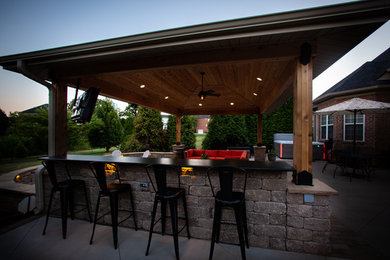 Patio kitchen - mid-sized transitional backyard stamped concrete patio kitchen idea in Other
