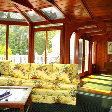Wood paneling accents this conservatory sunroom