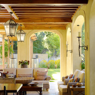 Idee per un grande portico mediterraneo dietro casa con un tetto a sbalzo e pavimentazioni in pietra naturale
