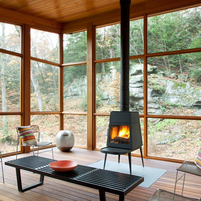 Inspiration for a contemporary porch remodel in New York with a fire pit, decking and a roof extension
