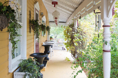 Shabby-chic style front veranda in Toronto with decking and a roof extension.