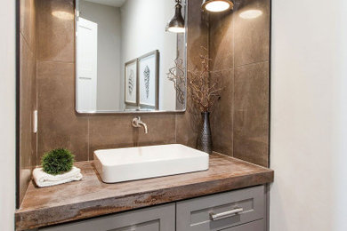 Powder room - small industrial powder room idea in San Francisco with gray cabinets and quartz countertops