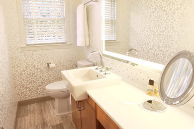 Example of a small trendy white tile and ceramic tile limestone floor powder room design in Houston with flat-panel cabinets, medium tone wood cabinets, quartz countertops, a one-piece toilet and white walls