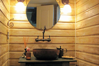 Inspiration for a small timeless powder room remodel in DC Metro with a vessel sink, wood countertops, a two-piece toilet, beige walls and black countertops