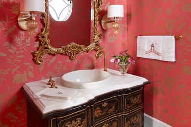 Powder room - mid-sized victorian porcelain tile and white floor powder room idea in Baltimore with furniture-like cabinets, black cabinets, red walls, a vessel sink, marble countertops and white countertops
