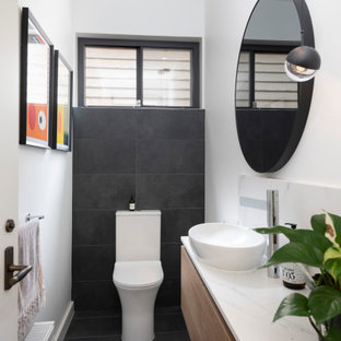 Design ideas for a contemporary powder room in Melbourne with a two-piece toilet, white walls, porcelain floors, a vessel sink, engineered quartz benchtops, grey floor and white benchtops.