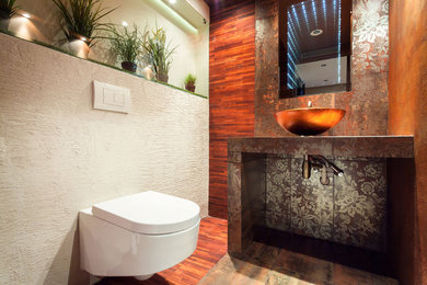 Mid-sized multicolored tile and porcelain tile porcelain tile powder room photo in Atlanta with a wall-mount toilet, orange walls, a vessel sink and tile countertops