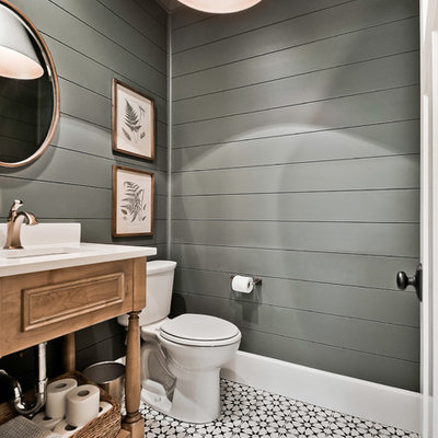 Powder room - large country multicolored floor powder room idea in Other with furniture-like cabinets, a two-piece toilet, an undermount sink, quartz countertops, white countertops, medium tone wood cabinets and gray walls