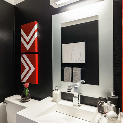 Example of a small minimalist powder room design in Toronto with black walls