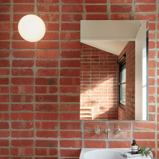 Scandinavian powder room in Melbourne with red walls, an integrated sink and white benchtops.