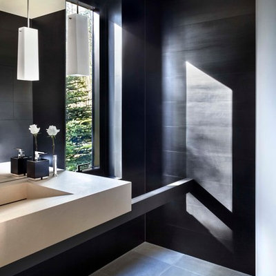 Trendy black tile powder room photo in Denver with an integrated sink