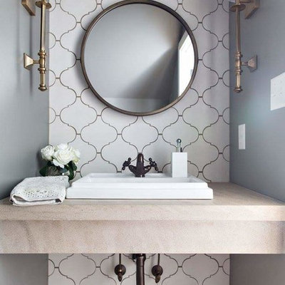 Small transitional white tile and cement tile brown floor powder room photo in Birmingham with a drop-in sink, limestone countertops and beige countertops