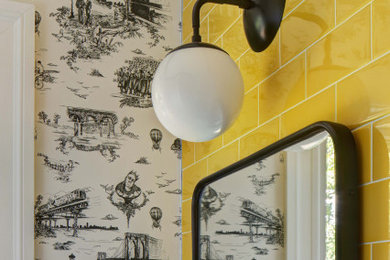 Example of a small minimalist yellow tile and ceramic tile porcelain tile, gray floor and wallpaper powder room design in New York with flat-panel cabinets, white cabinets, a two-piece toilet, white walls, an integrated sink and a floating vanity