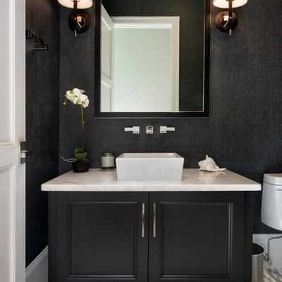 Inspiration for a mid-sized transitional ceramic tile and multicolored floor powder room remodel in Miami with recessed-panel cabinets, black cabinets, a two-piece toilet, black walls, a vessel sink and quartz countertops