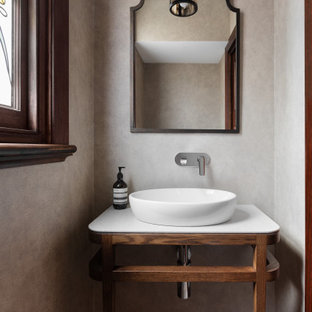 Inspiration for a mediterranean powder room in Melbourne with open cabinets, medium wood cabinets, beige walls, a vessel sink, multi-coloured floor, white benchtops and a built-in vanity.