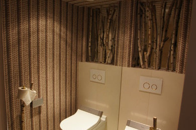 Design ideas for a small modern cloakroom in Other with a wall mounted toilet and multi-coloured walls.