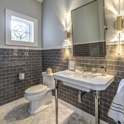 Inspiration for a transitional gray tile gray floor powder room remodel in Other with gray walls, a console sink and a one-piece toilet