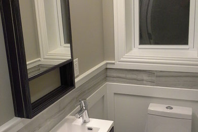 Powder room - small transitional gray tile and porcelain tile powder room idea in Chicago with a wall-mount sink, flat-panel cabinets, dark wood cabinets, a one-piece toilet and gray walls