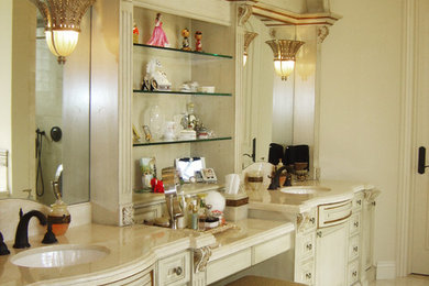 Large elegant powder room photo in Orange County with raised-panel cabinets and white cabinets