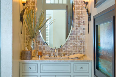 Example of a small beach style beige tile, white tile and stone tile marble floor powder room design in Miami with recessed-panel cabinets, beige walls, an undermount sink, granite countertops, blue cabinets and beige countertops