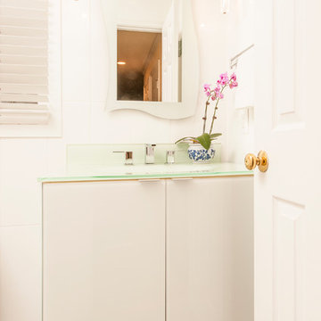 Contemporary Powder Room with Glass Vanity Cabinet