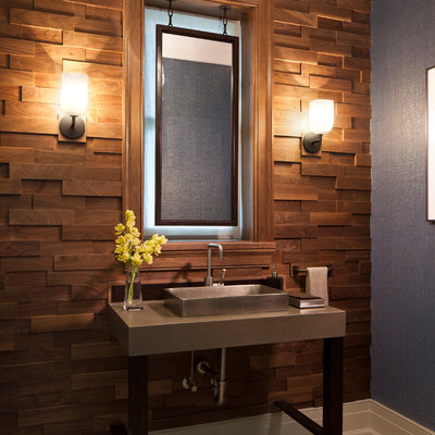 Mid-sized beach style brown tile limestone floor powder room photo in Chicago with concrete countertops, a vessel sink and blue walls