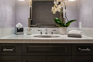 Example of a small trendy powder room design in Los Angeles with an undermount sink, recessed-panel cabinets and quartz countertops