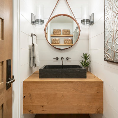 Powder room - small farmhouse medium tone wood floor and brown floor powder room idea in Salt Lake City with white walls, a vessel sink, wood countertops and brown countertops
