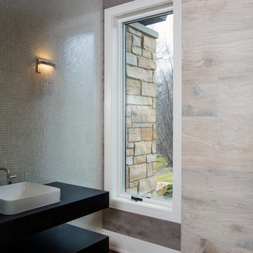 Formal Powder Room Featuring Floating Vanity and Solid Walls of Tile