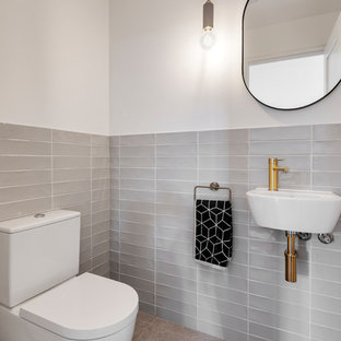 Inspiration for a contemporary powder room in Adelaide with gray tile, white walls, a wall-mount sink and grey floor.