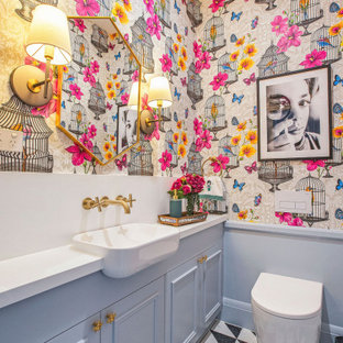 This is an example of a small eclectic powder room in Sydney with beaded inset cabinets, blue cabinets, a one-piece toilet, ceramic floors, a drop-in sink, engineered quartz benchtops and white benchtops.