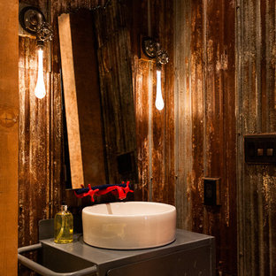 Industrial powder room in Vancouver with a vessel sink.