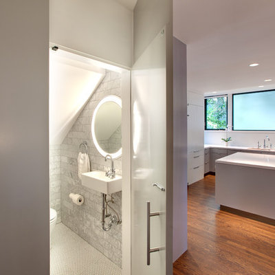 Trendy gray tile and stone tile powder room photo in Austin with a wall-mount sink