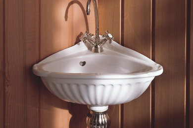 Example of a small country powder room design in Miami with a wall-mount sink