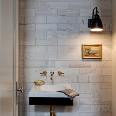 Example of a transitional marble tile powder room design in Chicago with a wall-mount sink