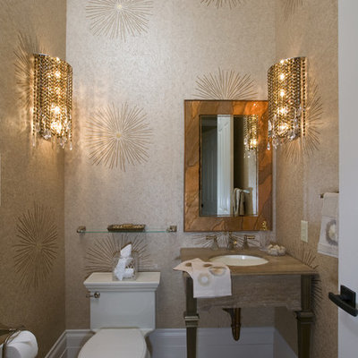 Inspiration for a small contemporary travertine floor and beige floor powder room remodel in Sacramento with an undermount sink, beige walls, a one-piece toilet, furniture-like cabinets, marble countertops and beige countertops