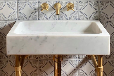 Small eclectic powder room photo with multicolored walls, a vessel sink and marble countertops