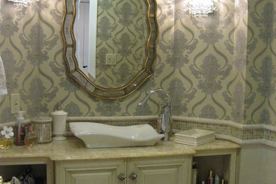 Example of a mid-sized eclectic beige tile, white tile and mosaic tile dark wood floor powder room design in Philadelphia with raised-panel cabinets, white cabinets, a one-piece toilet, beige walls, a vessel sink and solid surface countertops